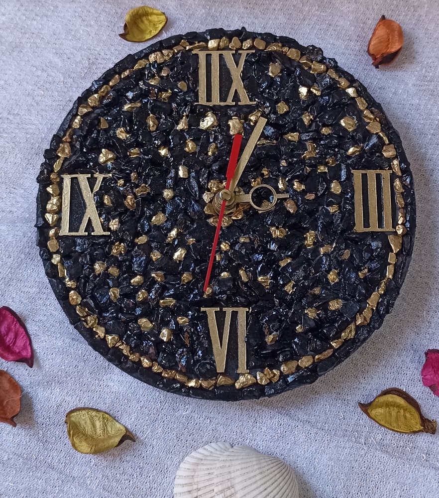 black and gold stone wall clock