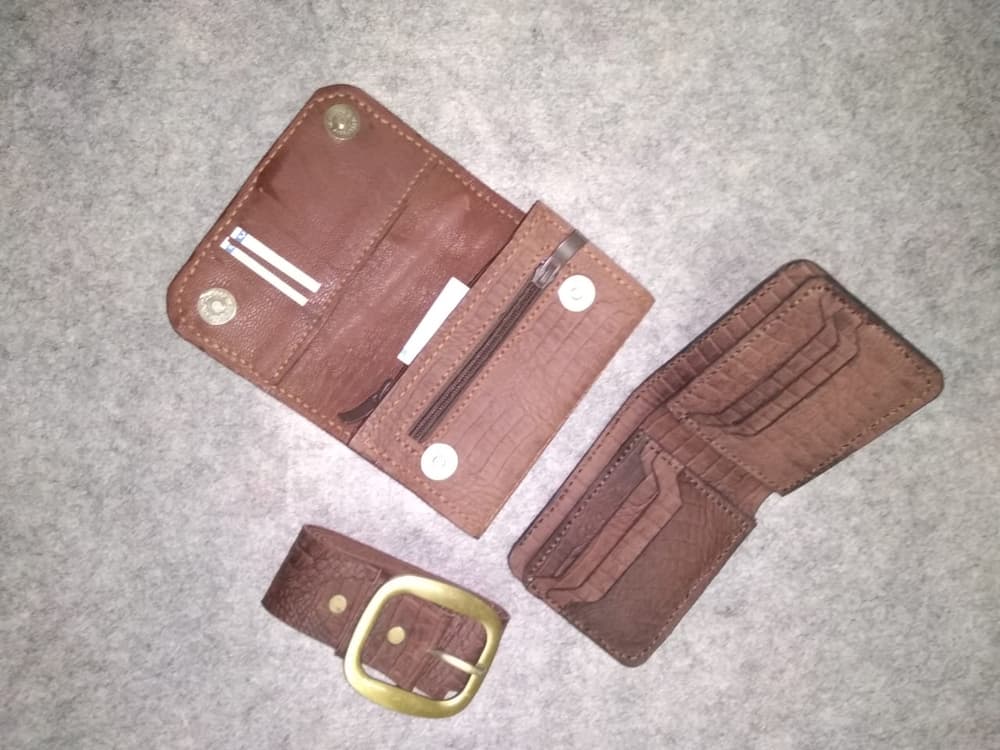 A set of men's wallet, women's wallet and belt