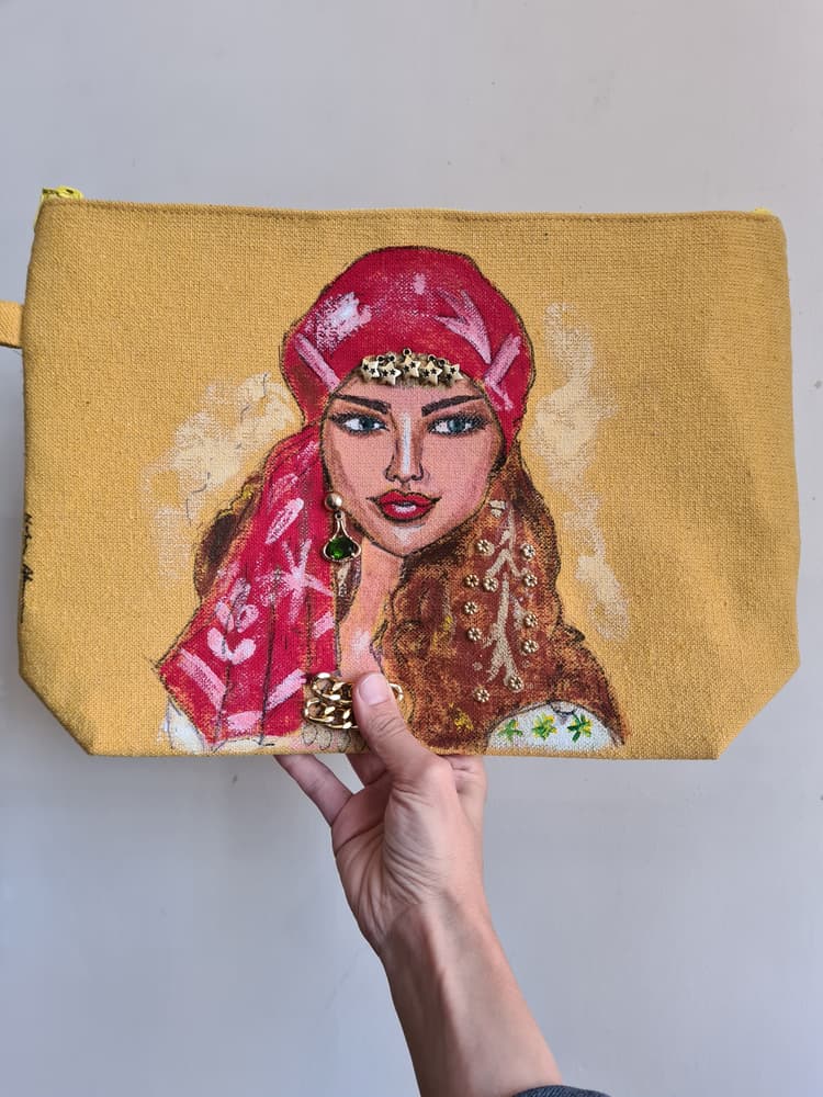 Yellow handpainted fabric canvas clutch bag with attached accessories 