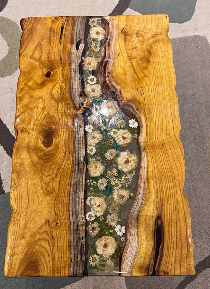 Epoxy table made with natural wood and dried flowers 