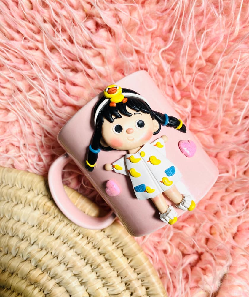 Cute doll with duckies on pink mug
