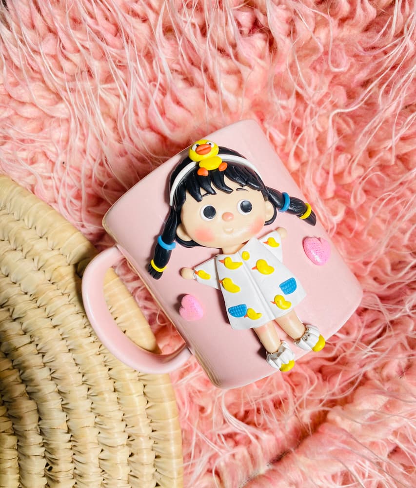 Cute doll with duckies on pink mug