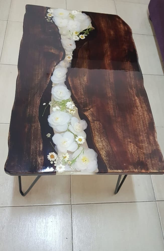 Epoxy table made with natural wood and artificial flowers