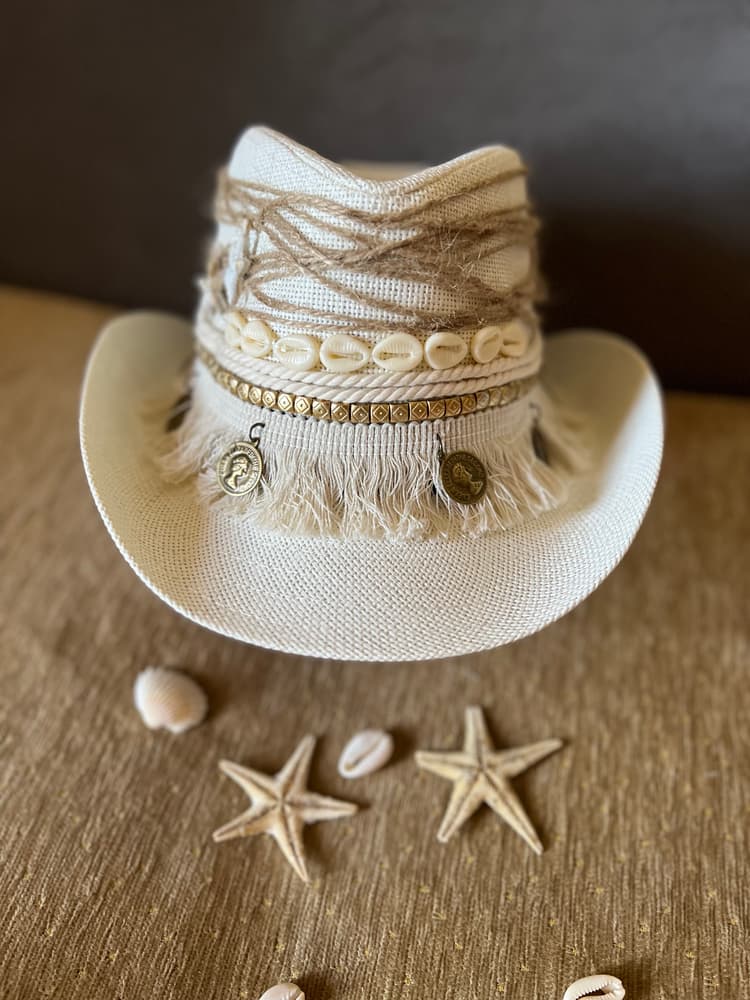 Sea shells off white cowboy hat